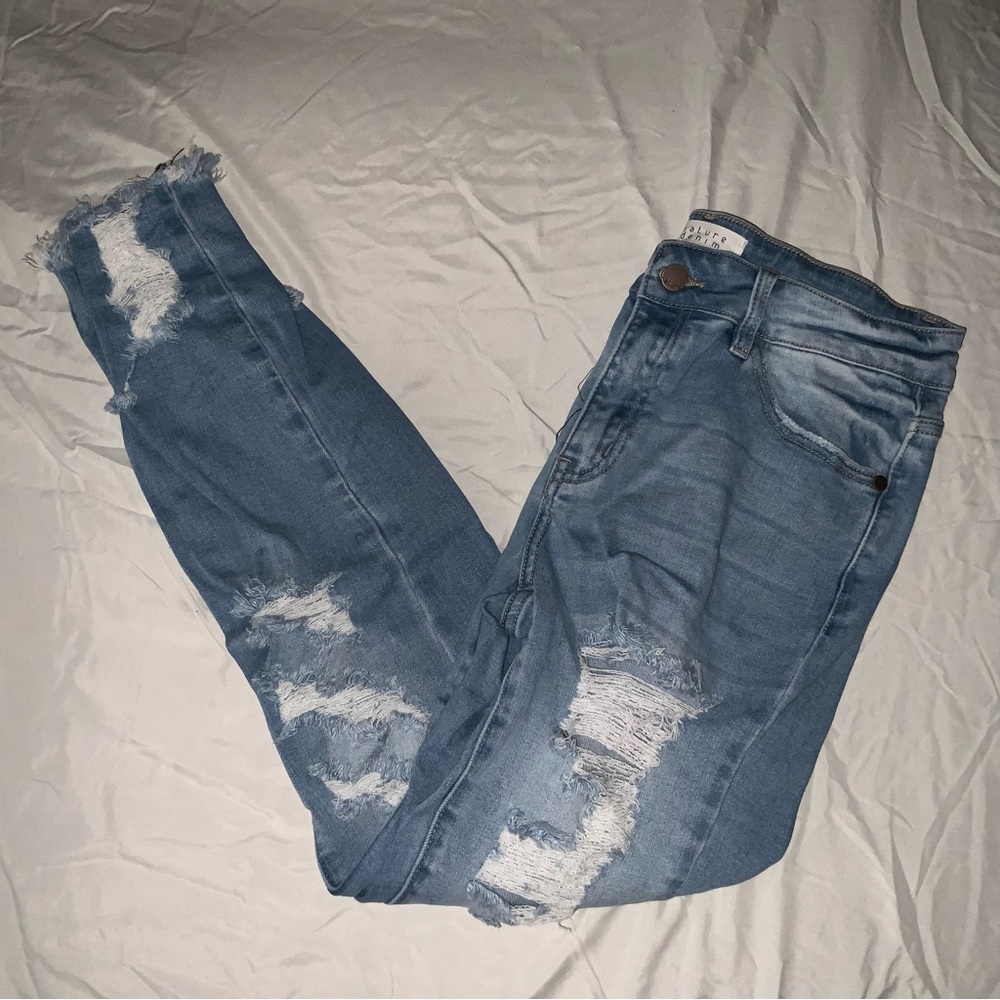 Very distressed light wash ankle jeans